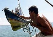 A Salvadoran fisher pulls a boat with 
their patron saint of the fishers &
quotSan Rafael Arcangel" inside, 
during the traditional celebration of 
the boats procession in honor of their 
patron saint of the fishers &quotSan 
Rafael Arcangel" at the port of La 
Libertad 44 km east of San Salvador, El 
Salvador October 23, 2003. About 25 
boats cross the coast of the pacific 
ocean every year to celebrate liturgic 
acts.  The effigy was found inside a 
trunk by fishers after a fire in a boat 
in the year of 1942. REUTERS/Luis 
Galdamez